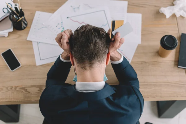 Top View Depressed Businessman Holding Credit Cards While Sitting Workplace — Stock Photo, Image