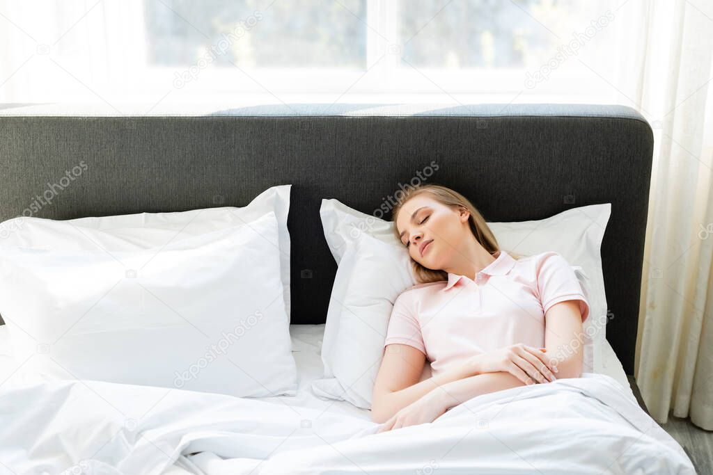 attractive woman sleeping in modern bedroom 
