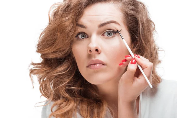 Woman putting eyeliner — Stock Photo