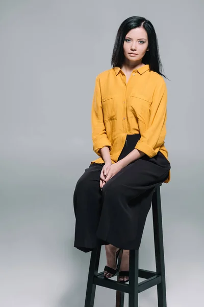 Brunette woman in yellow blouse — Stock Photo