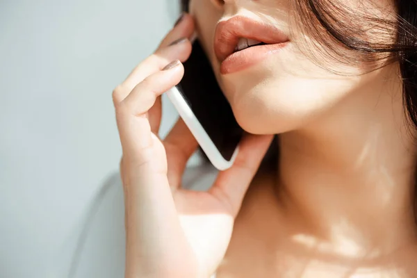 Cropped view of young woman talking on smartphone — Stock Photo