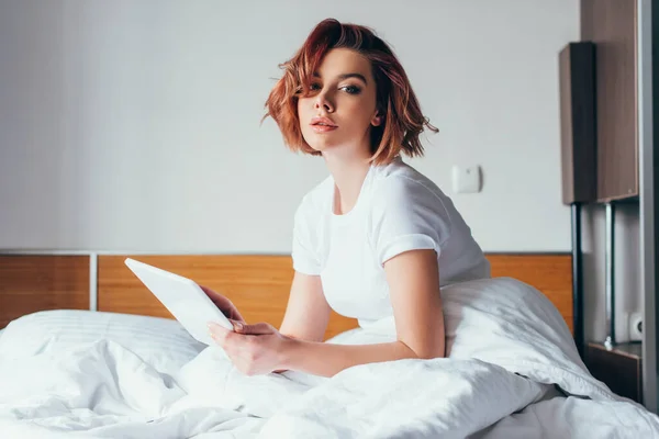 Attractive girl using digital tablet in bed on self isolation — Stock Photo