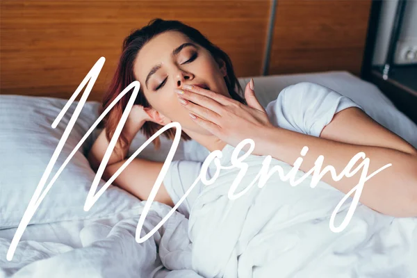 Beautiful girl yawning while lying in bed during quarantine with morning sign — Stock Photo