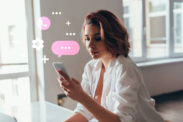 Attractive girl using smartphone with communication signs at home during self isolation — Stock Photo