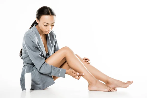 African american woman applying body cream — Stock Photo, Image