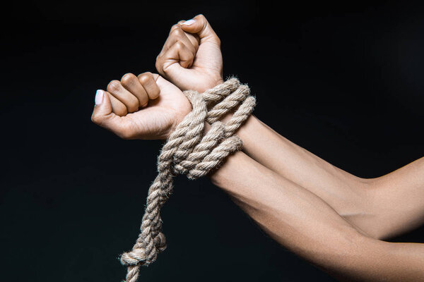female hands bound with rope