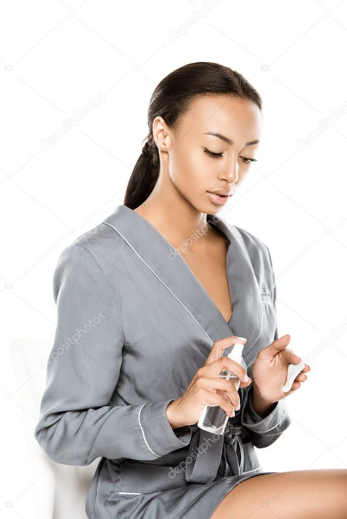african american woman applying micellar water