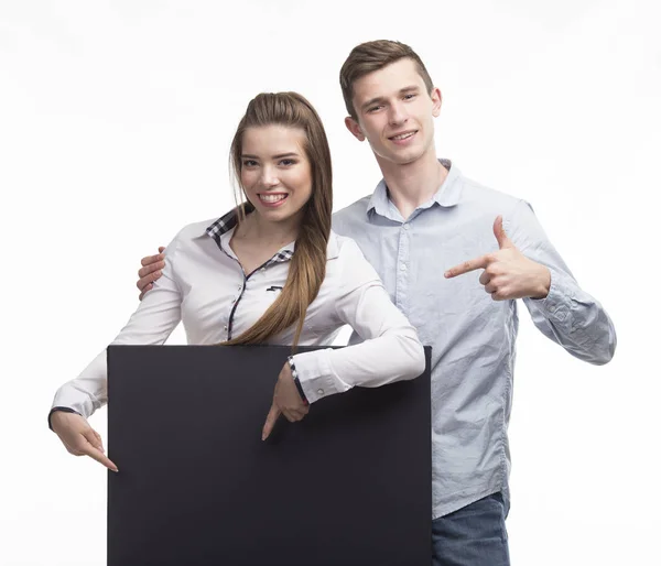 Молода щаслива пара показує презентацію, що вказує на плакат над — стокове фото
