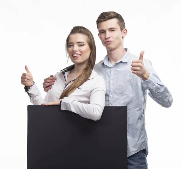 Unga lyckliga paret visar presentationen pekar på plakat över — Stockfoto
