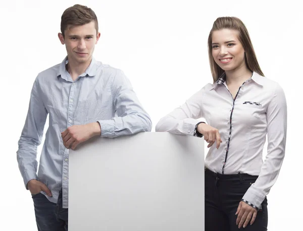 Young happy couple showing presentation pointing on placard — Stock Photo, Image