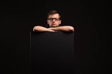 Genç sunu gösterilen, afiş üzerinde işaret eden adam sıkılmış