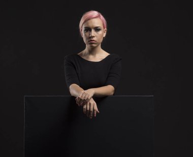 Sunu gösterilen, afiş üzerinde işaret eden genç seksi kadın