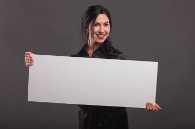 Sunu gösterilen, afiş üzerinde işaret eden genç kendine güvenen kadın