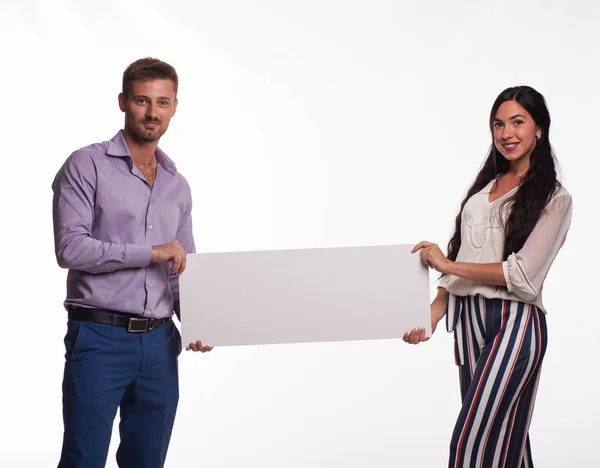 Unga lyckliga paret visar presentationen pekar plakat — Stockfoto