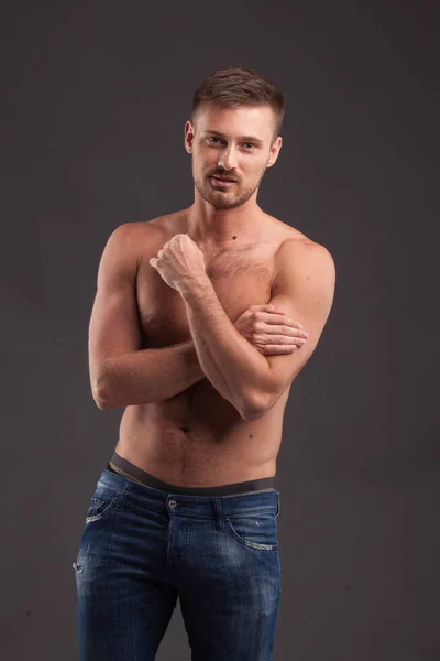 Young sexy man showing by hands — Stock Photo, Image