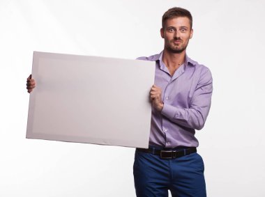 Genç sunu gösterilen, afiş üzerinde işaret eden adam şaşırttı