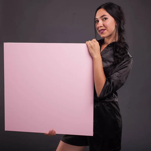 Young confident woman showing presentation, pointing on placard
