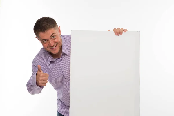 Young happy man showing presentation, pointing on placard. — Stock Photo, Image
