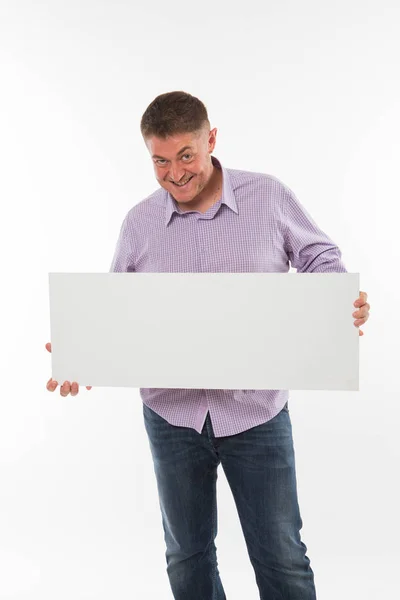 Young playful man showing presentation, pointing on placard. — Stock Photo, Image