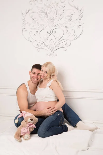 Hermosa pareja embarazada enamorada en el fondo . — Foto de Stock