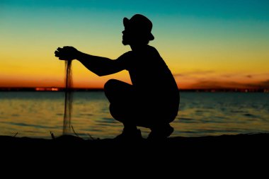 Gün batımı ve deniz arka plan üzerinde adam silüeti