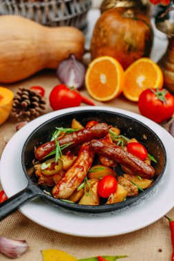Balkabaklarıyla sonbahar sofrası. Şükran Günü yemeği. Tavada kızarmış patatesli sosis.
