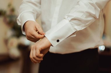 Damat kol düğmesi gömlek kol yakın çekim takılır.