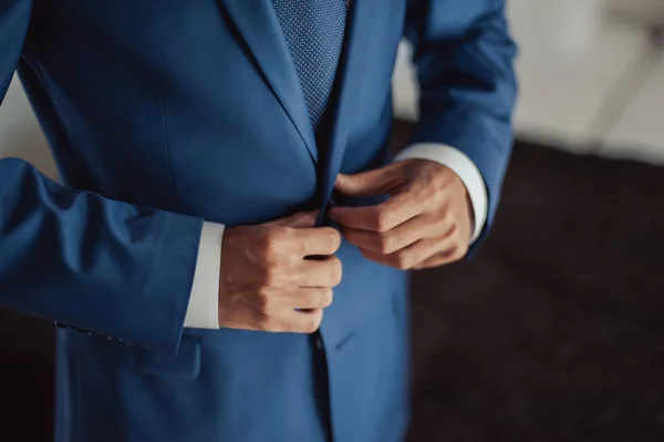 Elegante novio en chaqueta de boda con camisa blanca y corbata turquesa. Las manos del novio en traje azul . — Foto de Stock