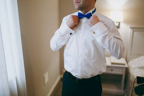 Man the groom in a wedding costume with butterfly. Hands, care, to correct, to adjust, fashion. Instagram colors toning — Stock Photo, Image