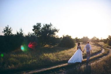 Kum bir yürüyüş gelin ve damat deniz alanı günbatımı mimari düğün çift çimen