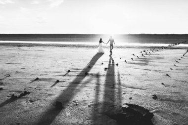 Kum bir yürüyüş gelin ve damat deniz alanı günbatımı mimari düğün çift çimen