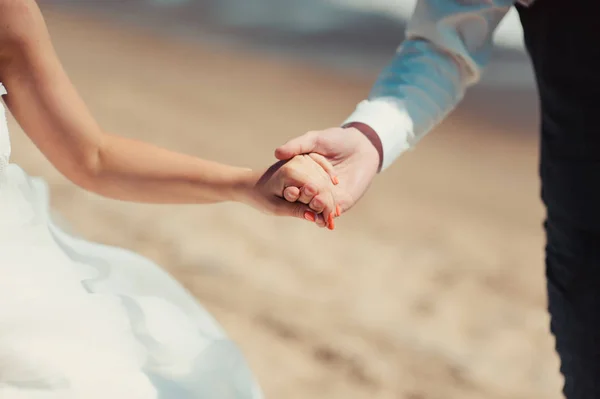 Holding hands. Closeup view of married couple holding hands — Stock Photo, Image