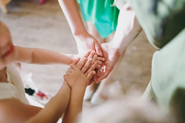 Nahaufnahme vieler Kinderhände, die vor Naturkulisse als Team zusammenhalten — Stockfoto