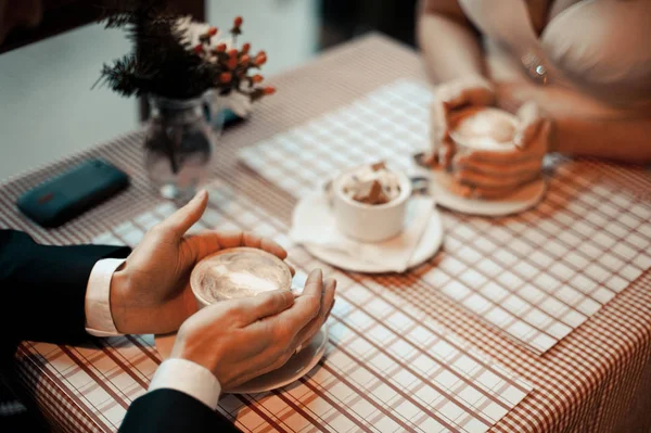 Çift kahve içiyor. Evli çift el ele tutuşarak closeup görünümü