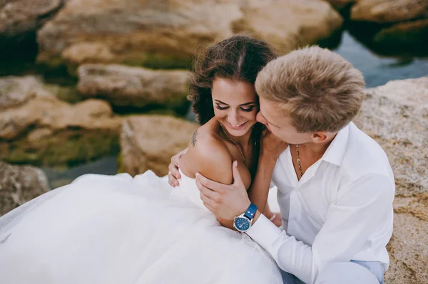 Schönes Hochzeitspaar auf einem Spaziergang am Meer — Stockfoto