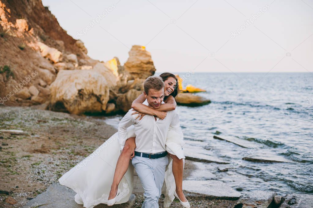 Beautiful wedding couple on a walk by the sea