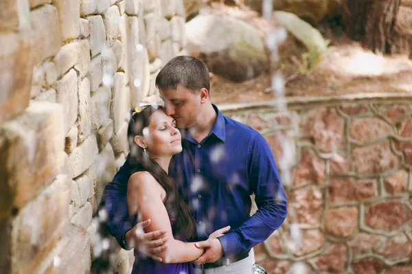 Par i kärlek gå på stenar med rinnande vatten — Stockfoto
