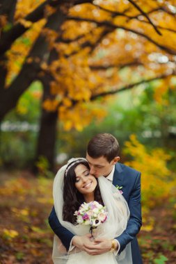 Güzel düğün çift sonbahar parkta bir yürüyüş üzerinde