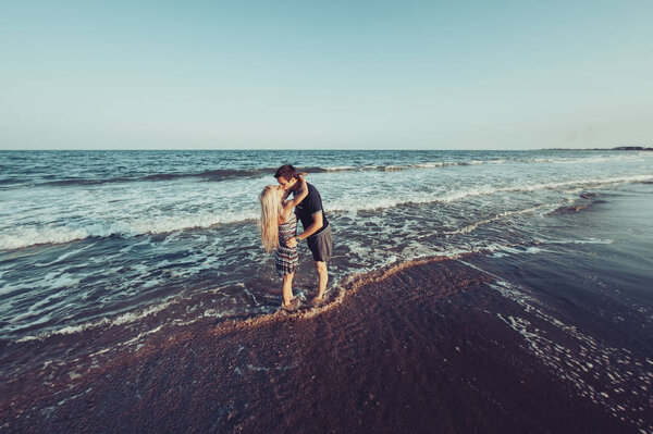 Young couple in love walking on the beach