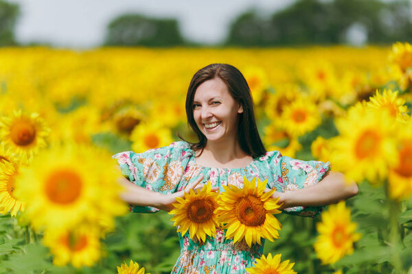 Girl applies sunflower flowers to her breast