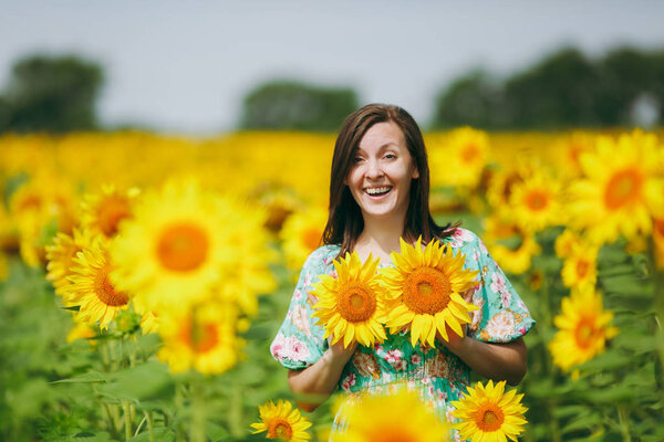 Girl applies sunflower flowers to her breast