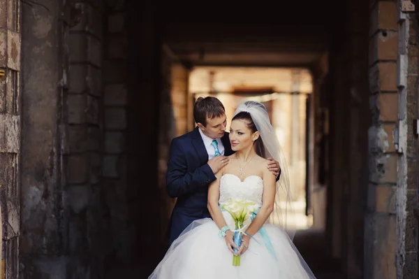 En el amor la pareja de boda cerca del arco en la calle — Foto de Stock