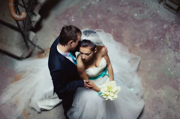 Förälskad bröllopsparet i en post på en spiraltrappa — Stockfoto