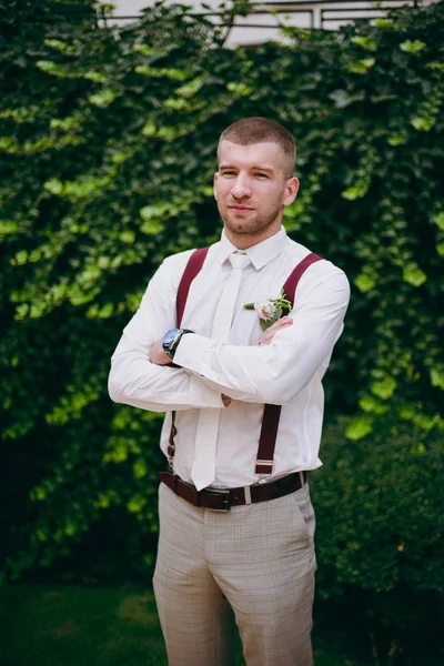 Portrait of the groom on a wedding day walk