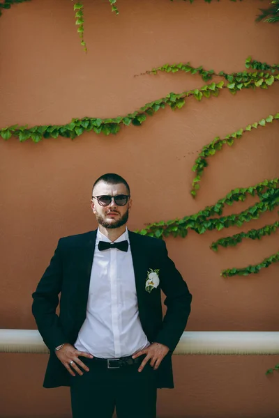 Portrait of the groom on a wedding day walk