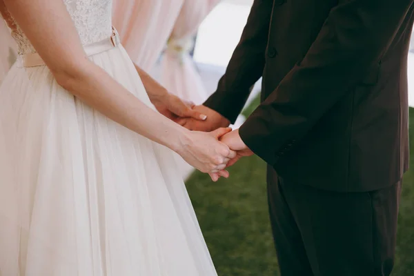 Liebendes Brautpaar hält zärtlich Händchen — Stockfoto