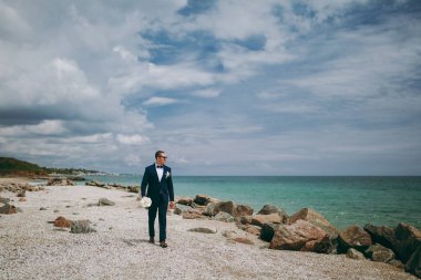 Bir takım elbise ve kravat denizde bir yürüyüşe damat