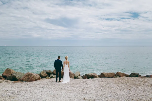 Groom and bride on a walk outdoors at the sea — Stock Photo, Image