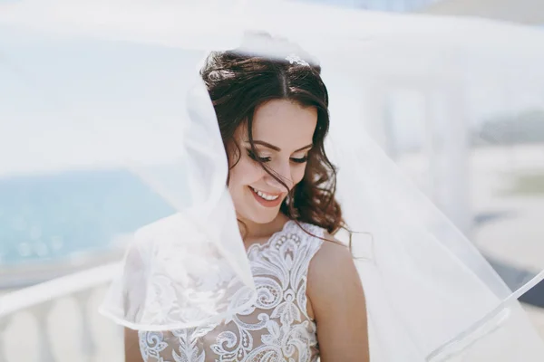 Beautiful brunette bride on a walk by the sea — Stock Photo, Image