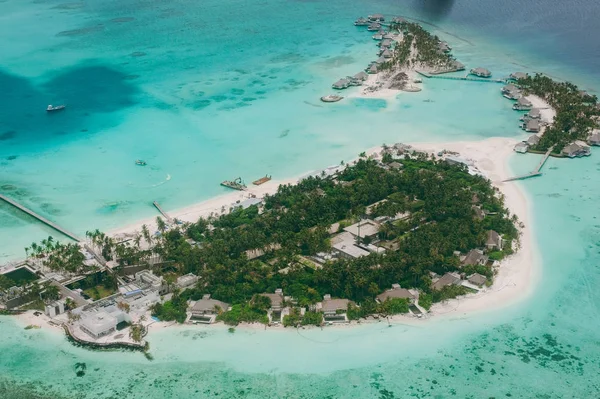 Tropical islands and atolls in Maldives in Indian Ocean from aerial view. Piece of paradise on the Earth. Good choice for vacation. Beautiful top view for wallpaper.